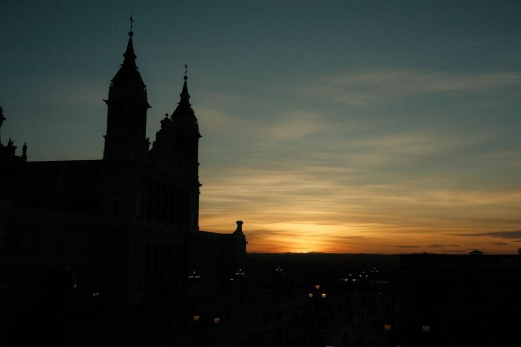 A stunning silhouette of a cathedral with a vibrant twilight sky in the background.